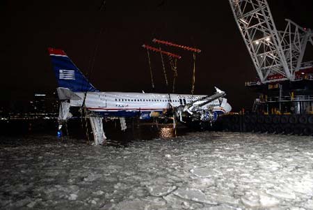 A crane lifts the wreckage of the US Airways airplane, that crashed in the Hudson River, out of the river in New York January 17, 2009.