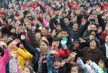 Villagers celebrate for moving to permanent dwellings in front of their new residences at Anren Village of Mianzhu City, southwest China's Sichuan Province, Jan. 18, 2009. A total of 332 Anren villagers whose houses collapsed or dilapidated during the May 12 massive earthquake last year feasted on Sunday to celebrate the resettlement. 