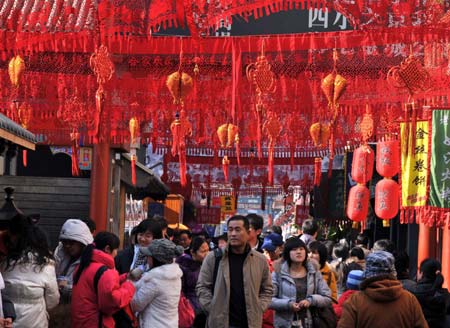 Tourists visit the bustling snack street of Wangfujing Street in Beijing, capital of China, Jan. 18, 2009, the traditional Chinese 'Little New Year' festival, a week before 'New Year,' or Spring Festival. 