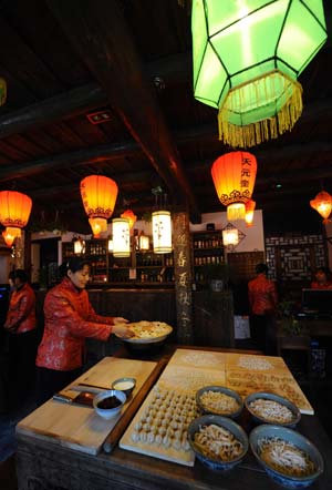 Workers make traditional food with flour in a guest house in Pingyao, north China's Shanxi Province, Jan. 17, 2009. The time-honoured Pingyao city listed among the UNESCO World Cultural Heritages prepares for the approaching Spring Festival with traditional celebrations. 