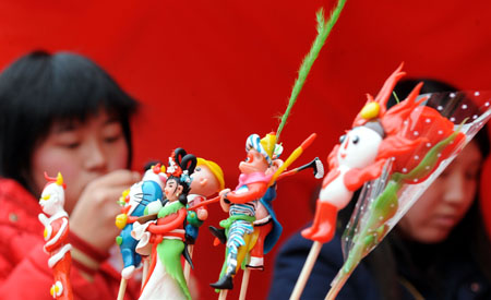 Folk artists make mianren, dough figurine sculptures, during a fair of the intangible cultural heritage, in Changsha, capital of central China's Hunan Province, Jan. 17, 2009.