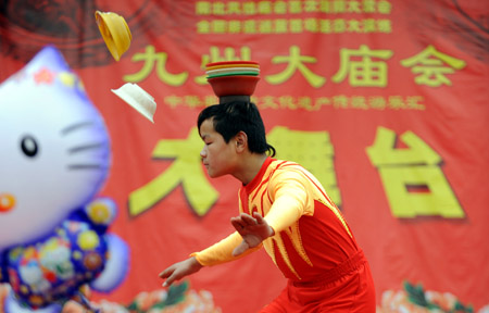 An acrobat performs during a fair of the intangible cultural heritage, in Changsha, capital of central China's Hunan Province, Jan. 17, 2009.