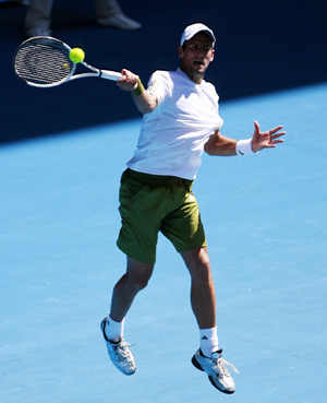 Novak Djokovic of Serbia returns the ball to Andrea Stoppini of Italy during their tennis match on the first day of the Australian Open in Melbourne Jan. 19, 2009. Defending champion Novak Djokovic won 6-2, 6-3, 7-5.