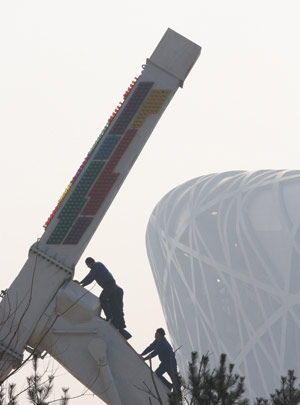 Workers speed up the construction of the carnival theme park seated northeast to the National Stadium known as the 'bird's nest' in Beijing, capital of China, Jan. 19, 2009. The park is planned to open during the Spring Festival holiday, which begins on Jan. 26 this year. [Xinhua]