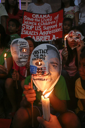 Filipino women and children shout anti war slogans as they gathered in a park in Quezon City, north of Manila, Jan. 19, 2009 to express their demand for justice to the Palestinian women and children who comprise a big number of those killed and injured by Israeli attacks on Gaza. 