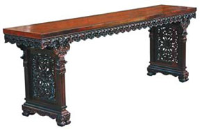 A replica Qing-style red sandalwood table with flat ends and lotus patterns. The original piece was collected by the Beijing Palace Museum. 