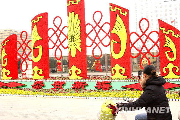 A citizen takes photos of New Year decorations while passing by Sanxiang Road in Suzhou, east China's Jiangsu province, on Monday, January 19, 2009. [Photo: Xinhuanet]