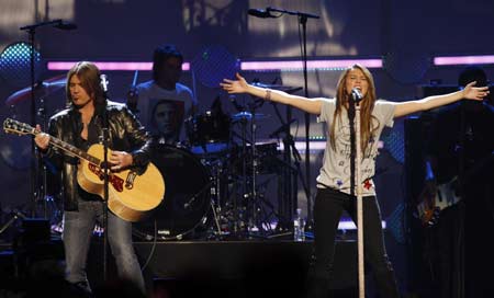 Miley Cyrus and her father Billy Ray Cyrus perform together at the 'Kids' Inaugural: We Are The Future' concert in Washington January 19, 2009. President-elect Barack Obama will take the Oath of Office on January 20.