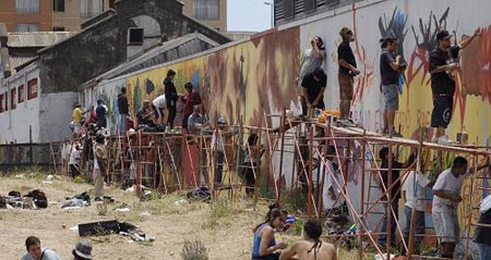 Graffiti artists paint on a wall during an international street art festival in Concepcion city, south of Santiago Jan. 19, 2009.