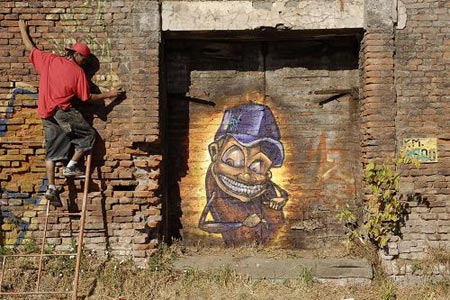 A graffiti artist paints on a wall during an international street art festival in Concepcion city, south of Santiago Jan. 19, 2009.