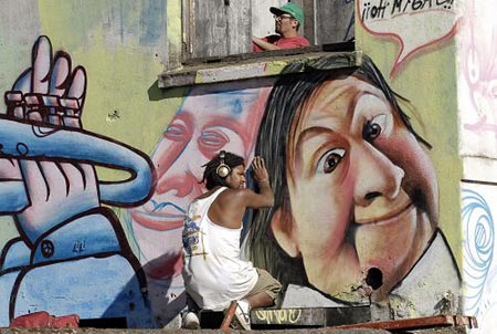 Graffiti artists paint on a wall during an international street art festival in Concepcion Jan. 19, 2009.