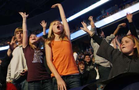 Children in the audience cheer as singer Miley Cyrus performs at the 'Kids' Inaugural: We Are The Future' concert in Washington January 19, 2009. U.S. President-elect Barack Obama will take The Oath of Office on January 20. 