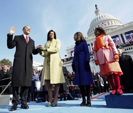 U.S. President Barack Obama takes the Oath of Office as the 44th U.S. President with his wife Michelle, daughters Malia (2nd R) and Sasha (R) by his side at the U.S. Capitol in Washington January 20, 2009. Obama became the first African-American president in U.S. history.