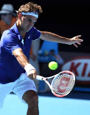 Roger Federer of Switzerland returuns a shot during the second round match of men's singles against Evgeny Korolev of Russia at the Australian Open tennis tournament in Melbourne, Jan. 21, 2009. Federer won 3-0 (6-2, 6-3, 6-1). 