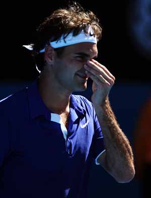 Roger Federer of Switzerland gestures during the second round match of men's singles against Evgeny Korolev of Russia at the Australian Open tennis tournament in Melbourne, Jan. 21, 2009. Federer won 3-0 (6-2, 6-3, 6-1). 