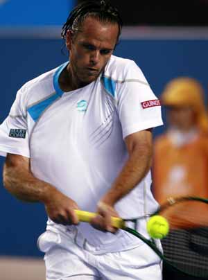 Xavier Malisse of Belgium returns the ball to Andy Roddick of the U.S. during the men's singles second round match at the Australian Open tennis tournament in Melbourne, Australia, Jan. 21, 2009. 