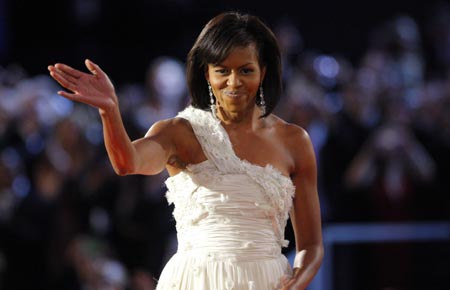 U.S. first lady Michelle Obama waves to the crowd after dancing her first dance of inauguration night with President Barack Obama at the leadoff Neighborhood Inaugural Ball in Washington January 20, 2009.