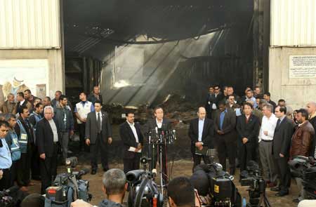 U.N. Secretary-General Ban Ki-moon (C) speaks to journalists in Gaza City January 20, 2009, in front of the United Nations compound that was struck by Israeli fire during Israel's offensive. 