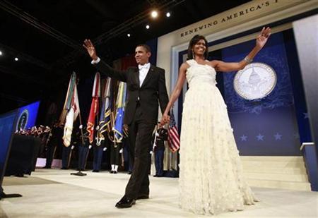 President Barack Obama (L) walks on stage with first lady Michelle Obama during the Western States Inaugural Ball in Washington, January 20, 2009. 