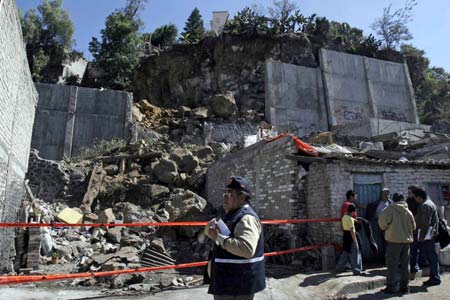 Rescuers inspect the scene of a landslide in Mexico City, capital of Mexico, Jan. 22, 2009.