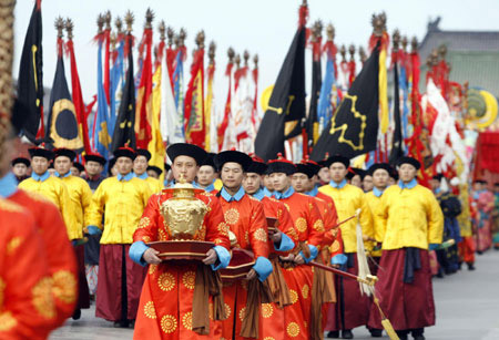 Actors who are dressed as a Qing Dynasty priests walk during a performance in Beijing January 23, 2009. 