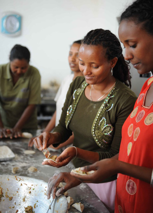 Ethiopian workers of China's ZTE Corporation make Chinese dumplings as they celebrate the Chinese Lunar New Year with Chinese workers in Addis Ababa, capital of Ethiopia, Jan. 25, 2009.