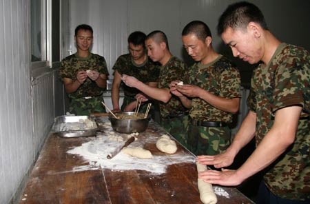 Chinese peacekeeping soldiers make dumplings to celebrate the Chinese Lunar New Year at their base in Monrovia, capital of Liberia, Jan. 25, 2009.