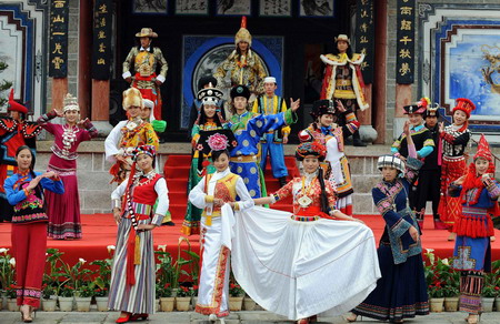 People wearing minority costumes pose for photographs in celebration of the Chinese Lunar New Year in the city of Kunming, southwest China's Yunnan province Monday January 26, 2009. Spring Festival, or the Chinese Lunar New Year, is the most important traditional Chinese festival that calls for family reunion. It falls on Jan. 26 this year.[Xinhua]