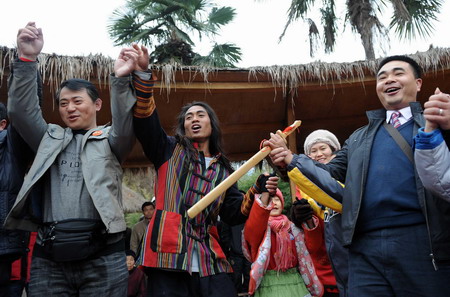 Tourists dance with locals in celebration of the Chinese Lunar New Year in the city of Kunming, southwest China's Yunnan province Monday January 26, 2009. Spring Festival, or the Chinese Lunar New Year, is the most important traditional Chinese festival that calls for family reunion. It falls on Jan. 26 this year.[Xinhua]