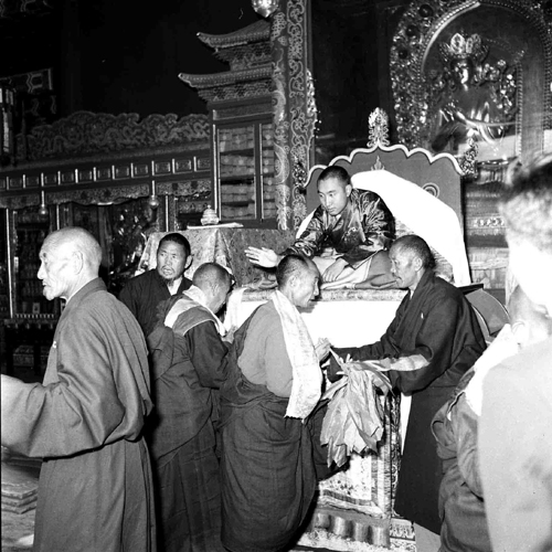 The 10th Panchen Lama touches the heads of pilgrims who have come to pay homage to him and seek his blessings. The photo was taken on Oct. 23, 1959 at the Beijing Office of the Government of Tibet Autonomous Region. 