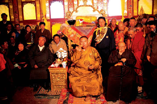 Panchen Lama engaged in a Buddhist ceremony together with his family and other masters of Buddhist texts. 