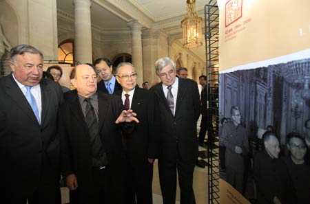 President of France's Senate Gerard Larcher (1st L) and Chairman of France-China Friendship Group Jean Besson (2nd L) look at Chinese pictures at the opening ceremony of a photo exhibition marking the 45th anniversary of the establishment of diplomatic relations between France and China in Paris, France, January 28, 2009. 