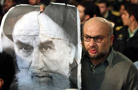 An Iranian man holds a portrait of Ayatollah Ruhollah Khomeini, the late founder of the Islamic republic, during a ceremony at Khomeini's mausoleum in Tehran, Iran, Jan. 31, 2009. Iran began on Saturday ceremonies marking the 30th anniversary of the 1979 Islamic Revolution. 