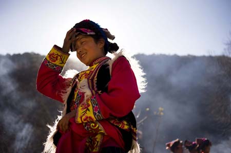 Eleven-year-old Chen Guoting, a girl of the Qiang ethnic group takes part in activities held in Qugu township of Maoxian County, southwest China's Sichuan Province, Jan. 30, 2009. The Qiang people in Maoxian celebrate the first Spring Festival after the tragic quake in Sichuan with full hope. 