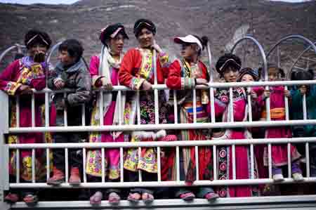 People of the Qiang ethnic group wait for vehicles to go back home after activities held in Qugu township of Maoxian County, southwest China's Sichuan Province, Jan. 30, 2009.