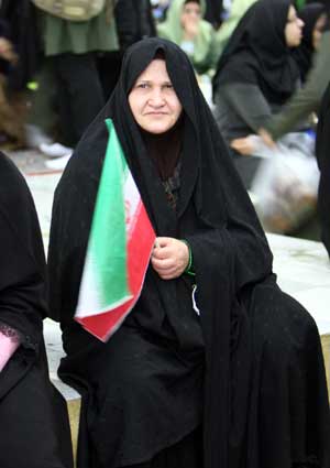 An Iranian woman holds a national flag during a ceremony at Khomeini's mausoleum in Tehran, Iran, Jan. 31, 2009. 