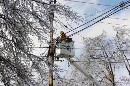 Linemen work to restore electricity to more than 200,000 Louisville residents, days after an ice storm hit the city January 30, 2009. 