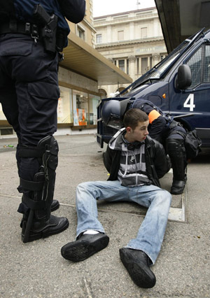 Riot policemen detain a protestor during a demonstration against the Davos World Economic Forum (WEF) in Geneva January 31, 2009