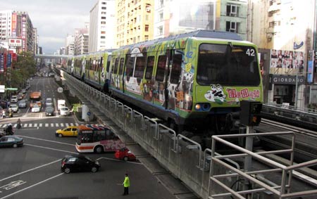 A train painted with cartoon images of giant pandas 'Tuan Tuan' and 'Yuan Yuan' is seen in Taipei, southeast China's Taiwan Province, Jan. 31, 2009. The special train was just part of the giant panda fever that swept Taiwan since the pair of pandas from the Chinese mainland made their official debut at a Taipei zoo on Jan. 26, 2009. (Xinhua/Wang Yan)