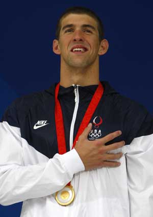 Michael Phelps of the U.S. listens to the national anthem during the medal presentation ceremony after the men's 4x100m freestyle relay swimming final at the National Aquatics Center during the Beijing 2008.