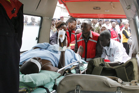 Paramedics at the Wilson airport in Nairobi attend to a man burnt after an oil truck crashed and burst into fire near the Rift Valley town of Molo Feb. 1, 2009. (Xinhua/Reuters Photo)