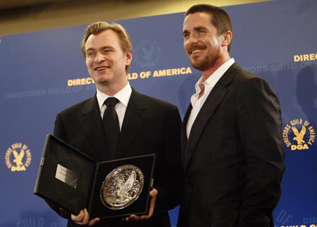 Director Christopher Nolan (L) holds his nominee plaque for the movie 'The Dark Knight' as he poses with actor Christian Bale at the 61st annual Directors Guild of America Awards in Los Angeles January 31, 2009. 