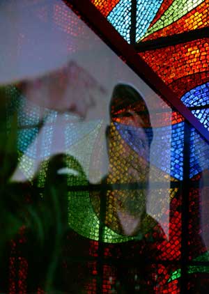 The video image of Fidel Castro is reflected on the glass during a photo exhibition marking the 50th anniversary of Cuban revolution, in Moscow, Russia, Feb. 1, 2009. 