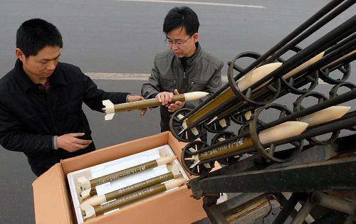 Meteorological staff at city Linfen, Shanxi Province are installing rockets in the hope to help induce bigger rain on Monday, Feb. 2, 2009. The city saw a lighter drizzle the same day prior to the blasts of the rain rockets, but was believed not enough at all to help relieve the lingering drought in the region. [Photo: Xinhua]