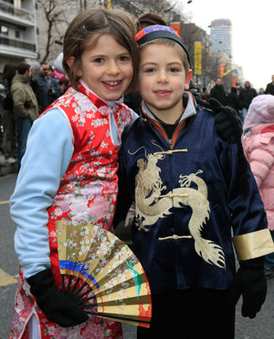 Girls in traditional Chinese dresses pose for a photo at a China Town in Paris, capital of France, on Feb. 1, 2009. The China Town held an annual Chinese Lunar New Year parade, attracting many locals here on Sunday.(Xinhua/Zhang Yuwei)