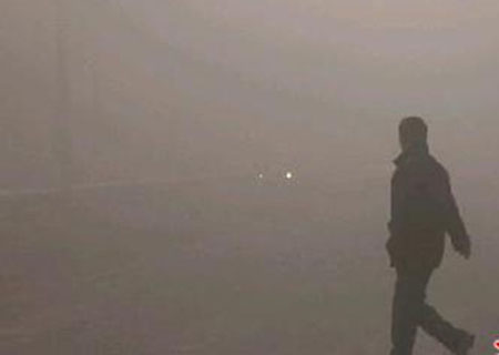 Pedestrian walks in dense fog in Urumqi city, northwest China's Xinjiang Uygur Autonomous Region Monday February 2, 2009. More than 3,600 people were stranded at an local airport after thick fog affected 76 domestic flights. [yaxin.com] 