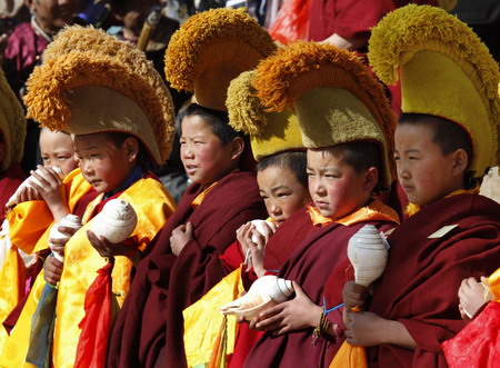 Young ethnic Tibetan monks attend a prayer meeting at a monastery in Tongren, northwest China's Qinghai province Monday, Feb. 2, 2009. (Photo: China Daily) 