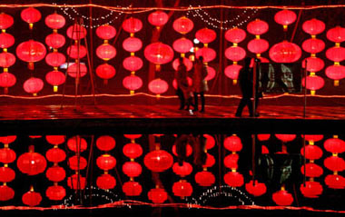 People enjoy the red lantern wall in Yongji city, north China's Shanxi Province, Feb. 2, 2009. Various lanterns are geared up for the impending Chinese Lantern Festival, which falls on Feb. 9 this year.