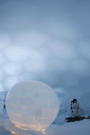 A woman uses a mobile phone at a bed room of an ice hotel during a photo opportunity in the Alpha Resort-Tomamu's ice village in Shimukappu town, Japan's northern island of Hokkaido, Feb. 3, 2009. (Xinhua/Reuters Photo)