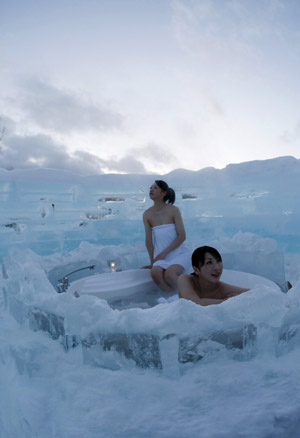 Women bathe at an outdoor bathroom of an ice hotel during a photo opportunity in the Alpha Resort-Tomamu's ice village in Shimukappu town, Japan's northern island of Hokkaido Feb. 3, 2009.(Xinhua/Reuters Photo)